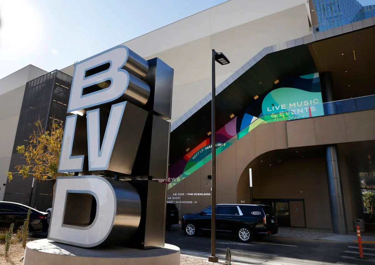 An eye level image of the BLVD logo outside the shopping complex drop off area showing escalators leading to the rooftop.